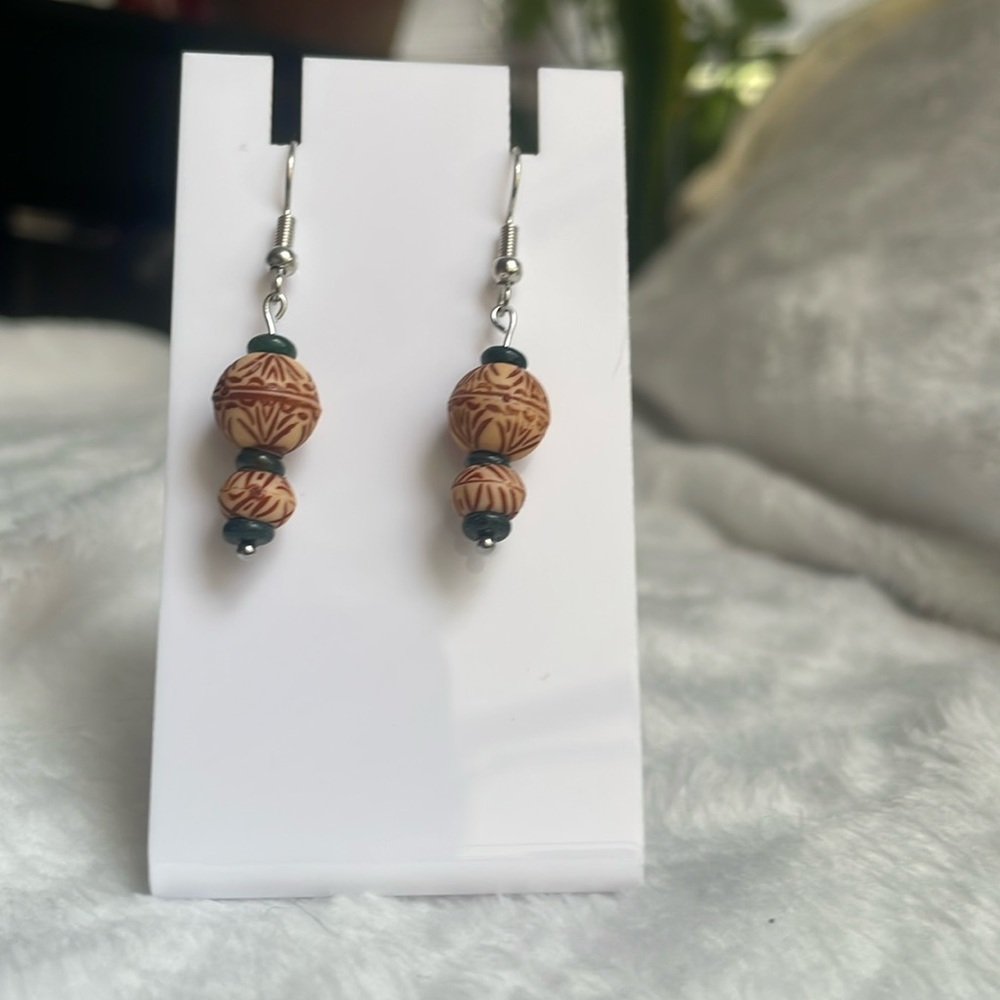 Handcrafted green and tan beaded earrings with stainless steel hooks.